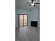 Bright living room boasting wood floors, fireplace, and sliding door access to balcony at 8455 W Sahara Ave # 258, Las Vegas, NV 89117