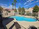 Community pool area with lounge chairs and palm trees, ideal for residents at 8455 W Sahara Ave # 258, Las Vegas, NV 89117