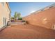 The backyard has desert landscaping, a high block wall, and a small patio area at 8543 Alpine Vineyards Ct, Las Vegas, NV 89139