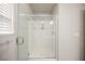 Modern bathroom featuring a sleek glass shower enclosure and bright marble-style tile at 8543 Alpine Vineyards Ct, Las Vegas, NV 89139