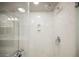 A modern shower with glass door and marble-look surround provides a luxurious and relaxing spa experience at 8543 Alpine Vineyards Ct, Las Vegas, NV 89139