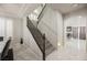 Elegant staircase with dark wood railing, white risers, and marble floors leading upstairs at 8543 Alpine Vineyards Ct, Las Vegas, NV 89139