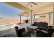Inviting back patio with comfortable seating and a built-in outdoor kitchen, perfect for entertaining at 8934 Windgate Ranch St, Las Vegas, NV 89166