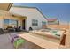 Backyard with a covered patio, seating area, and a beautiful pool, ideal for relaxation at 8934 Windgate Ranch St, Las Vegas, NV 89166