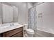 Well-lit bathroom featuring a shower-tub combination, patterned curtain, vanity, and tile flooring at 8934 Windgate Ranch St, Las Vegas, NV 89166