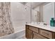 Bright bathroom with white tile, updated fixtures, and vanity with storage at 8934 Windgate Ranch St, Las Vegas, NV 89166