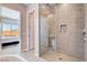 Modern bathroom featuring a glass enclosed shower with gray tiling and a built-in niche at 8934 Windgate Ranch St, Las Vegas, NV 89166