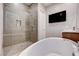 Contemporary bathroom featuring a luxurious standalone tub and a large glass-enclosed shower at 8934 Windgate Ranch St, Las Vegas, NV 89166