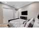 Bedroom with closet and mounted TV at 8934 Windgate Ranch St, Las Vegas, NV 89166