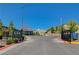 Welcoming entrance to Skye Canyon featuring a gated entry and well-manicured landscaping against a clear blue sky at 8934 Windgate Ranch St, Las Vegas, NV 89166