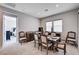Open dining area with a wet bar, stylish furnishings, and a glimpse into the adjacent bedroom at 8934 Windgate Ranch St, Las Vegas, NV 89166