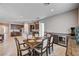 Spacious dining room with a formal table, wet bar, and open view into the kitchen with stainless appliances at 8934 Windgate Ranch St, Las Vegas, NV 89166