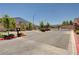 Community entrance to gated neighborhood featuring lush landscaping, security gate, and well-maintained surroundings at 8934 Windgate Ranch St, Las Vegas, NV 89166