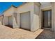 Close-up view of the garage and front door with stone accents and brick driveway at 8934 Windgate Ranch St, Las Vegas, NV 89166