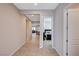 Open hallway leading to the living area and bedrooms with tile flooring at 8934 Windgate Ranch St, Las Vegas, NV 89166