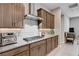Granite countertops and stainless gas cooktop, set among the modern cabinets and appliances in the kitchen at 8934 Windgate Ranch St, Las Vegas, NV 89166