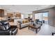 Inviting living room with tile floors, access to kitchen, and sliding glass doors at 8934 Windgate Ranch St, Las Vegas, NV 89166