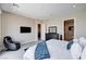 Comfortable bedroom featuring a bed, TV, massage chair, and access to a connected bathroom at 8934 Windgate Ranch St, Las Vegas, NV 89166