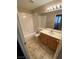 Standard bathroom features a tub and shower combination, tile floor, and a wood vanity with a sink at 8959 Coral Shale St, Las Vegas, NV 89123