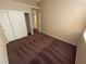 Bedroom featuring plush carpet, closet and entry doors, and neutral colored walls at 8959 Coral Shale St, Las Vegas, NV 89123