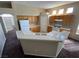 Kitchen featuring updated countertops and appliances with an adjacent breakfast bar for dining at 8959 Coral Shale St, Las Vegas, NV 89123