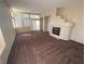 Spacious living room with a fireplace, bright windows, and plush carpet at 8959 Coral Shale St, Las Vegas, NV 89123