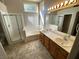 Bright main bathroom featuring a double sink vanity, separate shower and tub, and tile floors at 8959 Coral Shale St, Las Vegas, NV 89123
