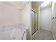 Well lit bathroom featuring a soaking tub, step-up seat, and glass enclosed shower at 901 E Jaybird St, Pahrump, NV 89048