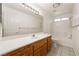 Bathroom featuring a white countertop, wood cabinets, and a bath and shower combo at 901 E Jaybird St, Pahrump, NV 89048