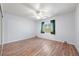 Bedroom featuring a ceiling fan, laminate flooring, and a bright sunny window at 901 E Jaybird St, Pahrump, NV 89048