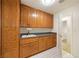 Laundry room features wood cabinets, sink, and laminate tile flooring at 901 E Jaybird St, Pahrump, NV 89048