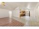 Open-concept living area showcasing wood floors and tile that leads into the kitchen area at 901 E Jaybird St, Pahrump, NV 89048