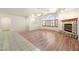 Bright living room featuring wood floors and a cozy stone fireplace at 901 E Jaybird St, Pahrump, NV 89048