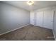 Bedroom featuring neutral walls, plush carpeting, and a closet with sliding doors at 9530 Windsor Forest Ct, Las Vegas, NV 89123