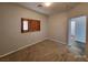 Comfortable bedroom with a window providing natural light and view to another room at 9530 Windsor Forest Ct, Las Vegas, NV 89123