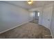 Bedroom featuring neutral walls, plush carpeting, a closet, and an entry door at 9530 Windsor Forest Ct, Las Vegas, NV 89123