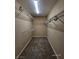 Walk-in closet with installed shelving for optimal organization and a carpeted floor at 9530 Windsor Forest Ct, Las Vegas, NV 89123