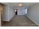 Expansive living room with neutral walls, plush carpet, and open doorway leading to other areas at 9530 Windsor Forest Ct, Las Vegas, NV 89123