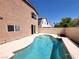 Backyard oasis featuring a private pool, patio area, and privacy wall, perfect for outdoor enjoyment at 9530 Windsor Forest Ct, Las Vegas, NV 89123