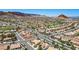 Expansive aerial view of the residential area with golf course, desert mountains and beautiful landscape at 9704 Brawley Dr, Las Vegas, NV 89134