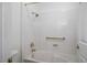 Bright bathroom featuring a tub with shower, gold fixtures and grab bar for safety and convenience at 9704 Brawley Dr, Las Vegas, NV 89134