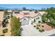 Aerial view of a single-story home with a well-maintained front yard and a two-car garage on a sunny day at 9704 Brawley Dr, Las Vegas, NV 89134