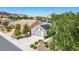 Exterior view of a charming home with a well-manicured front yard, solar panels, and a two-car garage at 9704 Brawley Dr, Las Vegas, NV 89134