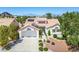 Inviting home exterior with lush landscaping, solar panels, and a spacious driveway leading to a two-car garage at 9704 Brawley Dr, Las Vegas, NV 89134