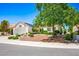 Charming single-story home with a well-maintained front yard and a two-car garage on a sunny day at 9704 Brawley Dr, Las Vegas, NV 89134