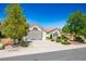 Charming single-story home with a well-maintained front yard and a two-car garage on a sunny day at 9704 Brawley Dr, Las Vegas, NV 89134