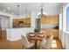 Open-concept kitchen and dining area featuring hardwood floors, modern lighting, and stylish furniture at 9704 Brawley Dr, Las Vegas, NV 89134