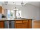 Kitchen island with granite countertop, stainless steel dishwasher, and a view of the backyard at 9704 Brawley Dr, Las Vegas, NV 89134