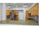 Kitchen with granite countertops, wooden cabinets, stainless steel appliances, and elegant lighting at 9704 Brawley Dr, Las Vegas, NV 89134