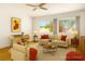 Staged living room featuring hardwood floors, comfortable seating, and large windows providing ample light at 9704 Brawley Dr, Las Vegas, NV 89134